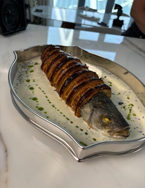 A sea bass Wellington with a latticed pastry crust in Champagne sauce with tarragon oil and caviar